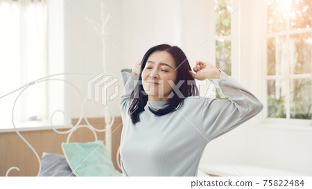 Stretching middle-aged woman, refreshing morning, good sleep, health care 75822484