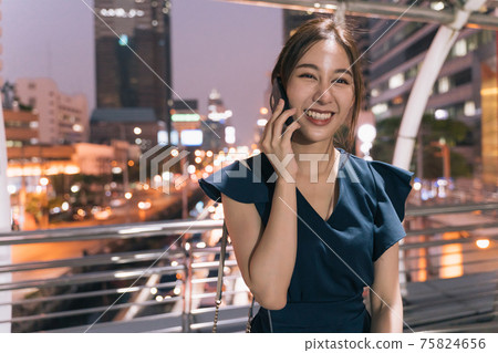 Happy woman talking over phone Happy woman talking over phone 75824656