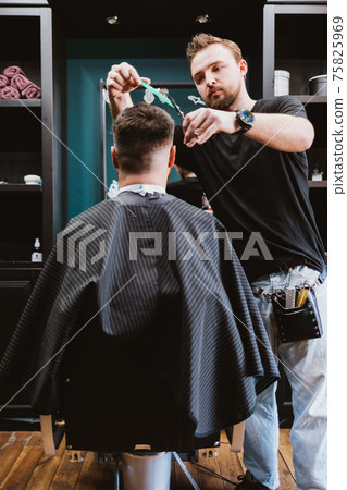 Men's haircut process, hairdresser cutting hair of male client Men's haircut process, hairdresser cutting hair of male client 75825969