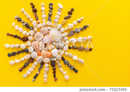 Abstract sun from sea pebbles and seashells 75825995