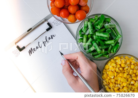 Meal plan. Three Bowls of frozen vegetables food of yellow corn, green beans, red tomatoes. Colors of traffic light. Harvest Food preservation for winter. 75826670