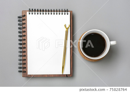 open notepad, cup of coffee, succulents, golden pen on gray background, spiral notebook on table Business, planning, education, morning life working from home concept Top view Flat lay Mock up 75828764