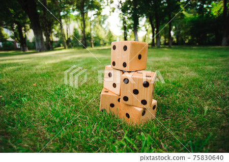 Outdoor games - Big dices on the green grass. Outdoor games - Big dices on the green grass. 75830640