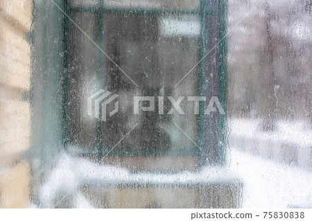 Dirty scratched glass with dew drops 75830838