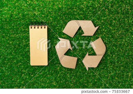 Craft paper on grass, recycling concept, top view 75833667