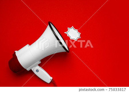 Electronic megaphone with speech bubble on red background 75833817