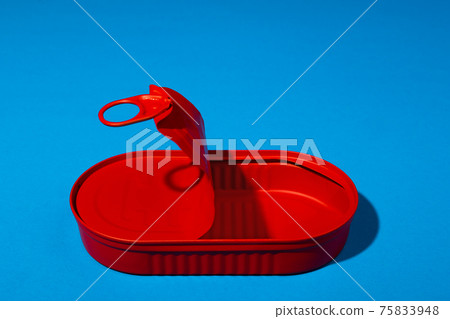 Red tin can on blue background close up Red tin can on blue background close up 75833948