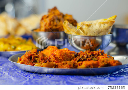 Chicken jalfrezi and chicken curry with various rice and onion Bhajis and Samosas Chicken jalfrezi and chicken curry with various rice and onion Bhajis and Samosas 75835165