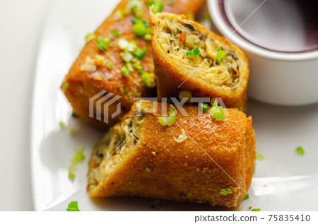 Delicious croquettes with sauerkraut and mushrooms served with hot red borscht 75835410
