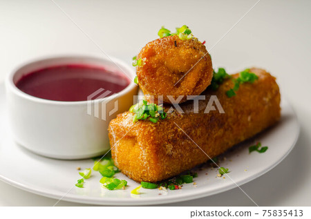 Delicious croquettes with sauerkraut and mushrooms served with hot red borscht 75835413