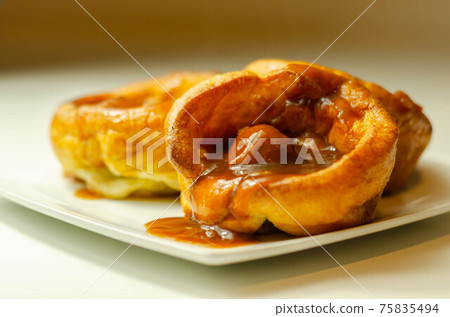 Traditional English Yorkshire pudding with meatballs and thick gravy sauce 75835494