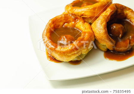 Traditional English Yorkshire pudding with meatballs and thick gravy sauce 75835495