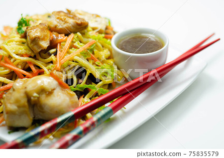 Cooked chicken breast pieces with savory garlic and ginger soy sauce and  noodles, black fungus mushrooms, savoy cabbage, and carrot 75835579