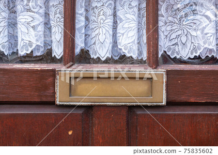 Old letterbox in the door, traditional way of delivering letters to the house, old mailbox Old letterbox in the door, traditional way of delivering letters to the house, old mailbox 75835602