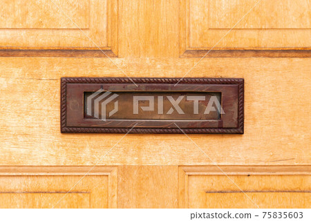 Old letterbox in the door, traditional way of delivering letters to the house, old mailbox Old letterbox in the door, traditional way of delivering letters to the house, old mailbox 75835603
