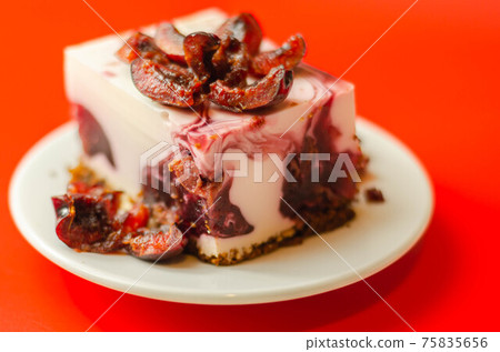 Japanese cheesecake with cherry sauce and fresh cherries on the ceramic plate and red background Japanese cheesecake with cherry sauce and fresh cherries on the ceramic plate and red background 75835656