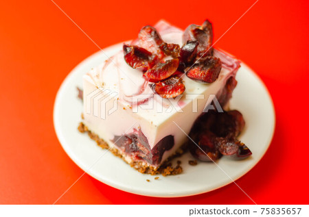 Japanese cheesecake with cherry sauce and fresh cherries on the ceramic plate and red background Japanese cheesecake with cherry sauce and fresh cherries on the ceramic plate and red background 75835657