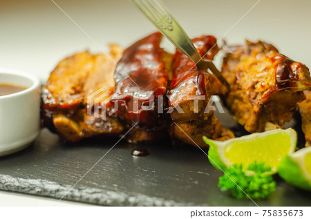 Pork ribs in a smoky flavour barbecue seasoning with a honey barbecue sauce 75835673