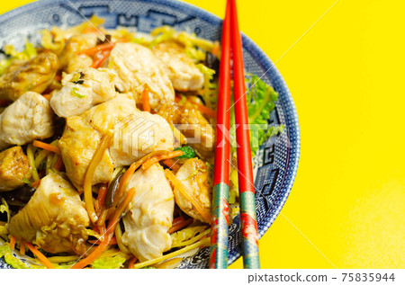Cooked chicken breast pieces with savory garlic and ginger soy sauce and  noodles, black fungus mushrooms, savoy cabbage, and carrot 75835944