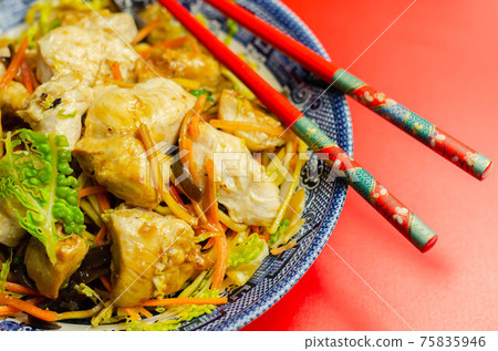 Cooked chicken breast pieces with savory garlic and ginger soy sauce and  noodles, black fungus mushrooms, savoy cabbage, and carrot 75835946