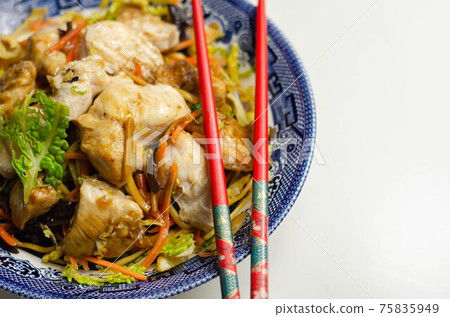 Cooked chicken breast pieces with savory garlic and ginger soy sauce and  noodles, black fungus mushrooms, savoy cabbage, and carrot 75835949