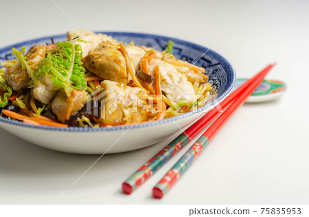 Cooked chicken breast pieces with savory garlic and ginger soy sauce and  noodles, black fungus mushrooms, savoy cabbage, and carrot 75835953