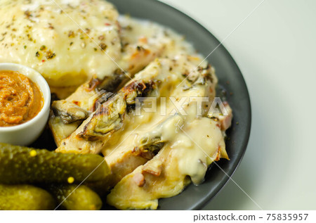 Chicken breast with sliced mushrooms, ham, in cheese sauce with mash potato, pickled red cabbage, and gherkin Chicken breast with sliced mushrooms, ham, in cheese sauce with mash potato, pickled red cabbage, and gherkin 75835957