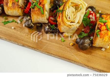 Baked pieces of tortilla wrap with chicken breast and Grana Padano cheese on the wood Baked pieces of tortilla wrap with chicken breast and Grana Padano cheese on the wood 75836029
