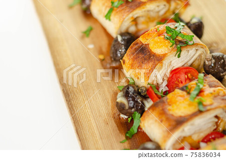Baked pieces of tortilla wrap with chicken breast and Grana Padano cheese on the wood Baked pieces of tortilla wrap with chicken breast and Grana Padano cheese on the wood 75836034