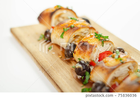 Baked pieces of tortilla wrap with chicken breast and Grana Padano cheese on the wood Baked pieces of tortilla wrap with chicken breast and Grana Padano cheese on the wood 75836036