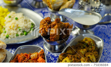 Chicken jalfrezi and chicken curry with various rice and onion Bhajis and Samosas Chicken jalfrezi and chicken curry with various rice and onion Bhajis and Samosas 75836084