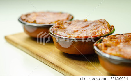 Traditional french onion gratin soup served in a ceramic bowl on a wood Traditional french onion gratin soup served in a ceramic bowl on a wood 75836094