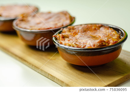 Traditional french onion gratin soup served in a ceramic bowl on a wood 75836095