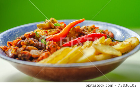 Chicken breast fillet with a chilli and cheese tomato sauce with crispy potato slices and minty bean salad on a blue plate Chicken breast fillet with a chilli and cheese tomato sauce with crispy potato slices and minty bean salad on a blue plate 75836102