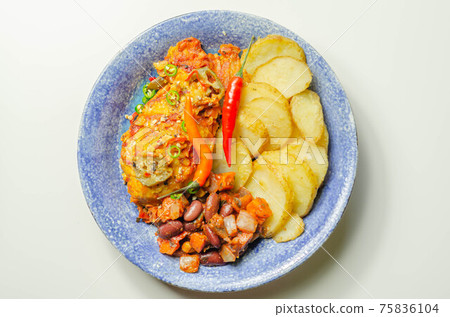 Chicken breast fillet with a chilli and cheese tomato sauce with crispy potato slices and minty bean salad on a blue plate Chicken breast fillet with a chilli and cheese tomato sauce with crispy potato slices and minty bean salad on a blue plate 75836104