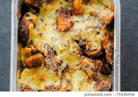 Fried potato fries coated topped with mature cheddar and Monterey Jack cheeses, jalapeno and bacon sauce, finished with mozzarella and parsley Fried potato fries coated topped with mature cheddar and Monterey Jack cheeses, jalapeno and bacon sauce, finished with mozzarella and parsley 75836456
