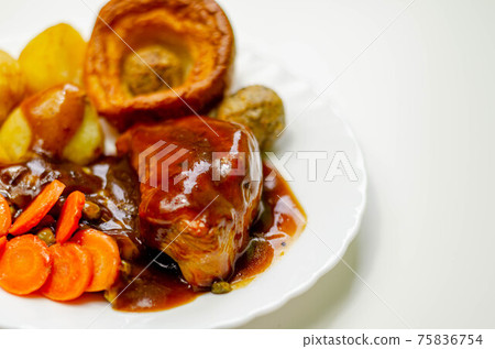 Roast potatoes and roast chicken breast in a chicken and white wine gravy with peas, carrots, pork and onion stuffing and a Yorkshire pudding Roast potatoes and roast chicken breast in a chicken and white wine gravy with peas, carrots, pork and onion stuffing and a Yorkshire pudding 75836754