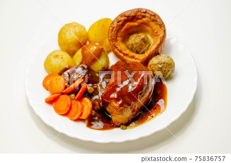 Roast potatoes and roast chicken breast in a chicken and white wine gravy with peas, carrots, pork and onion stuffing and a Yorkshire pudding Roast potatoes and roast chicken breast in a chicken and white wine gravy with peas, carrots, pork and onion stuffing and a Yorkshire pudding 75836757