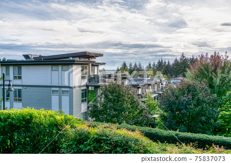 Top of residential building on cloudy sky background Top of residential building on cloudy sky background 75837073