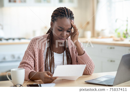 African American Female Freelancer Having Stress While Working With Papers At Home African American Female Freelancer Having Stress While Working With Papers At Home 75837411