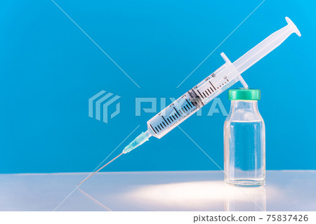 Potential trials stage concept on blue background. Close up Vials with sterile needle syringe. Research and Development, Vaccination. Potential trials stage concept on blue background. Close up Vials with sterile needle syringe. Research and Development, Vaccination. 75837426