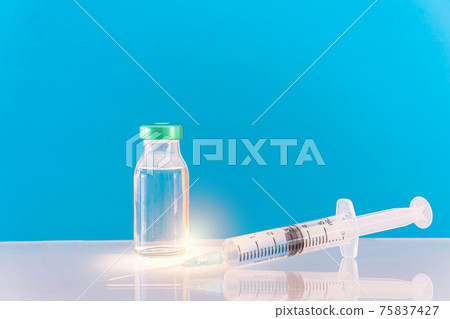 Potential trials stage concept on blue background. Close up Vials with sterile needle syringe. Research and Development, Vaccination. Potential trials stage concept on blue background. Close up Vials with sterile needle syringe. Research and Development, Vaccination. 75837427