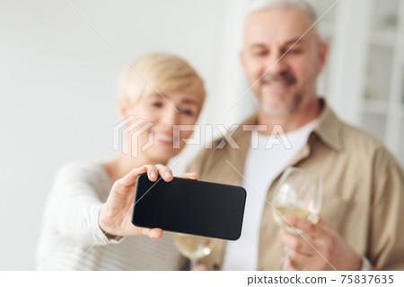 Selfie on modern phone, celebrate holiday and mobile app Selfie on modern phone, celebrate holiday and mobile app 75837635