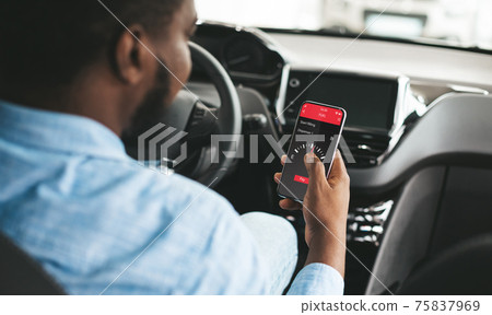 Cashless technology or digital payment for fuel energy. Black guy using mobile app to buy petrol online inside his car Cashless technology or digital payment for fuel energy. Black guy using mobile app to buy petrol online inside his car 75837969