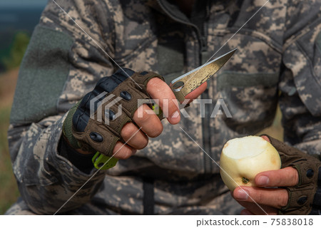 A man with a knife in the forest. A man with a knife in the forest. 75838018