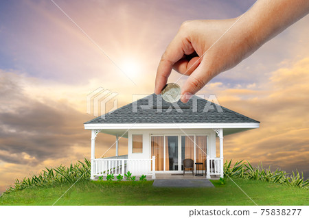 The hands of a businessman hold money and the other hand holds a house. The idea of saving money to buy a house 75838277
