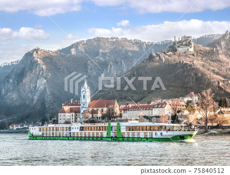 Durnstein village during spring time with tourist ship on Danube river in Wachau, Austria Durnstein village during spring time with tourist ship on Danube river in Wachau, Austria 75840512