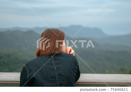 solo asian woman hipster traveler taking photo to mountain at outdoor bar of coffeeshop solo asian woman hipster traveler taking photo to mountain at outdoor bar of coffeeshop 75840821