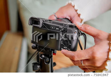 Asian female blogger setting up her digital camera before making a new video for vlog 75841947