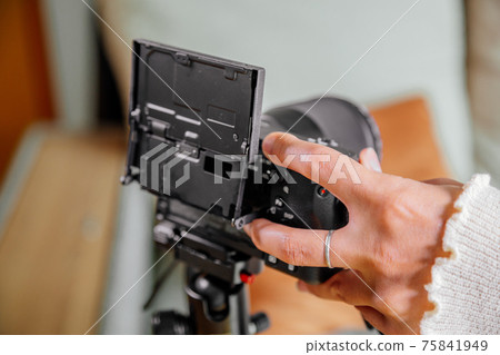 Asian female blogger setting up her digital camera before making a new video for vlog 75841949